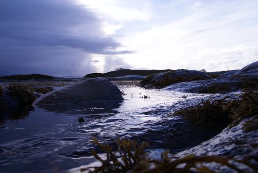 The picture was taken on the shore. The picture illustrates the movements in the sea and in the Norwegian nature.