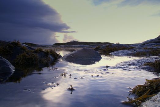 The picture was taken on the shore. The picture illustrates the movements in the sea and in the Norwegian nature.