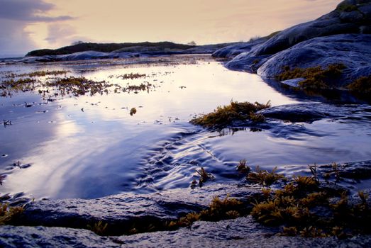 The picture was taken on the shore. The picture illustrates the movements in the sea and in the Norwegian nature.