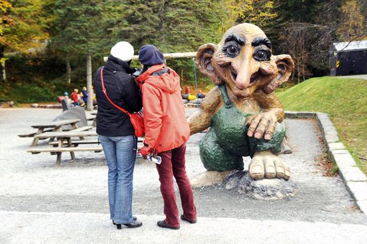 Tourists take a photo of troll, Bergen, Norway 