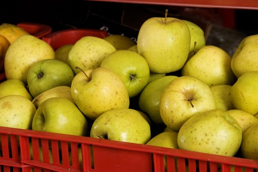 red box with fresh green apples ready for market