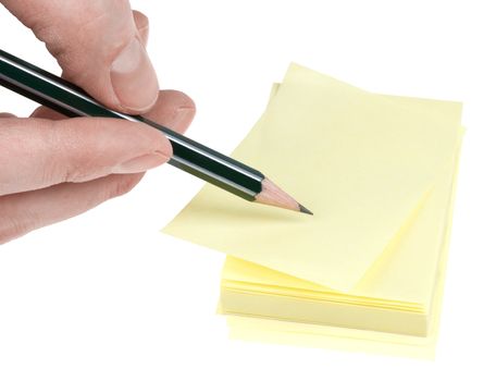 Human hand with pencil write on yellow memories sticker. Clipping path.