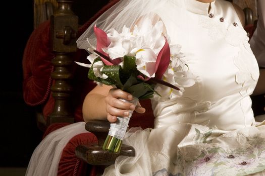 Beautiful white bridal bouquet on wedding dress 