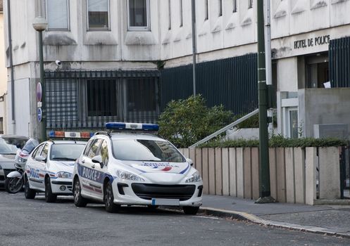 Two french police car parked in the street in front of police station