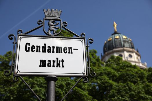 signpost at Gendarmenmarkt in Berlin/Germany with Dome in the background on a sunny day