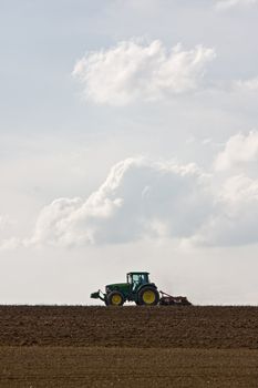 silhouette of a tractor on farmland
