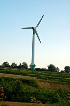 Windmill turning on the sunset