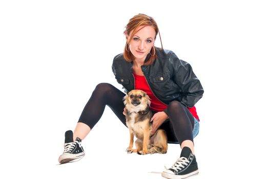 Pretty brunette with her pet Chihuahua against a pure white background