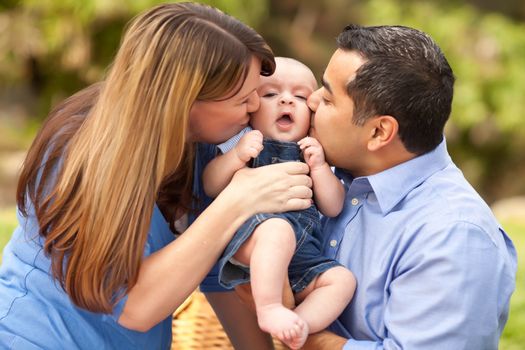 Happy Mixed Race Parents Playing with Their Giggling Son.