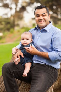 Handsome Hispanic Father and Son Posing for A Portrait in the Park.