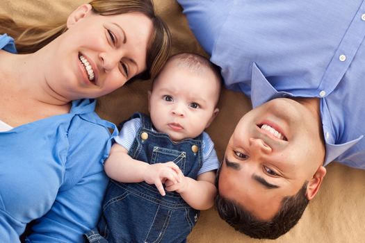 Mixed Race Family Playing Face Up on the Blanket.