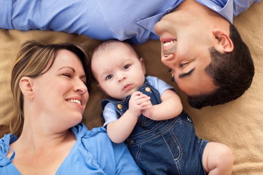 Mixed Race Family Playing Face Up on the Blanket.