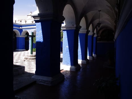 Sunny monastery courtyard with blue galleries