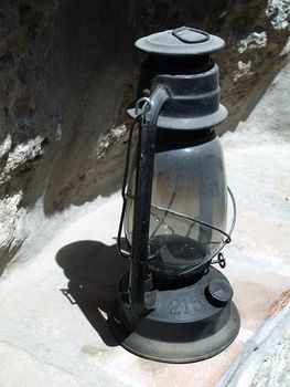 Old oil lamp standing on the staircase