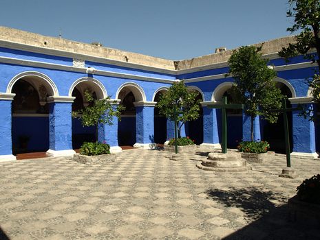 Sunny, monastery courtyard with blue galleries