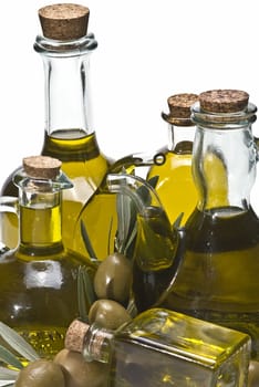 Olive oil bottles and olives isolated on a white background.