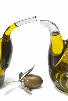 Olive oil bottles and olives isolated on a white background.