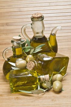 Olive oil bottles on a bamboo mat.