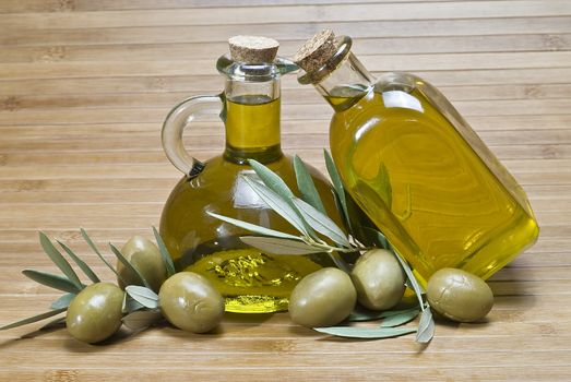 Olive oil bottles on a bamboo mat.