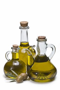 Olive oil bottles and olives isolated on a white background.