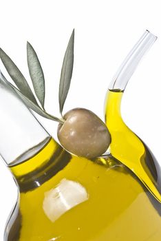 Olive oil bottles and olives isolated on a white background.