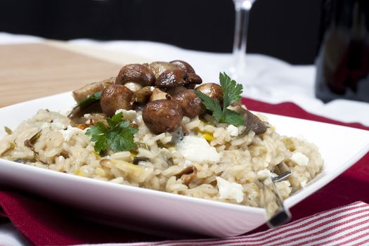 Mushroom risotto with sauteed mushrooms and crumbled cheese.