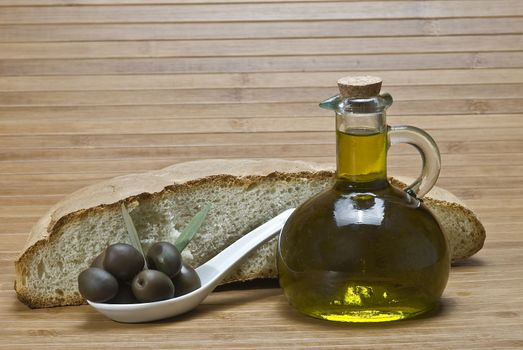 Olive oil bottles on a bamboo mat.