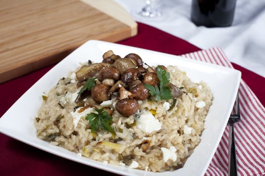 Mushroom risotto with sauteed mushrooms and crumbled cheese.