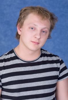 Portrait of the tousled guy in a striped T-shirt