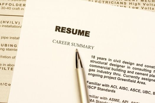 Resume curriculum vitae with newspaper ads as background.