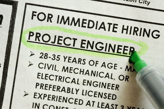 looking for something in newspaper, project engineer immediate hiring concept.