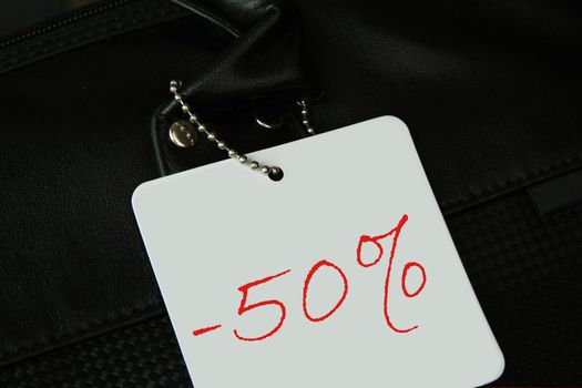 close-up of a Sale tag 50% off against black- no copyright infringement