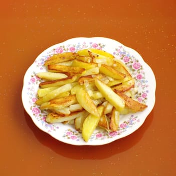 roasted potatoes on a plate on the orange  background