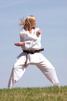 Karate blond girl training outdoor