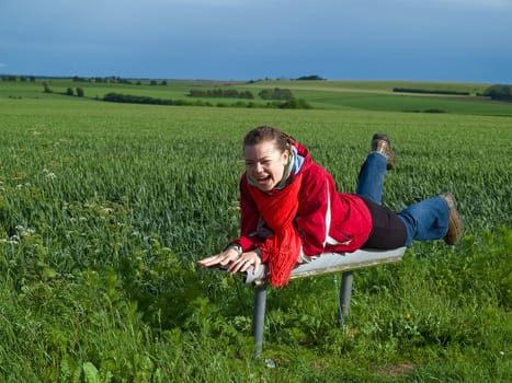 Beautiful attractive smiling young happy woman girl in a green wheat field