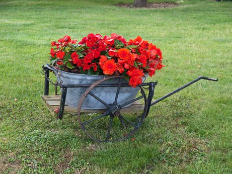 A garden decorated with an old wagon turned into a planter