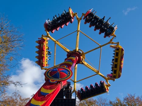 Giant modern colorful merry-go-round chairoplane in an amusement park
