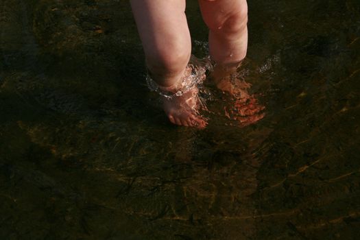 toddlers feet walding on the beach for the first time.