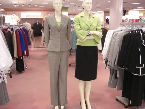 A store department is displaying a whole range of women's designer clothes, some on mannequins.