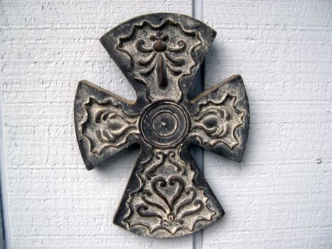 A decorative crossed, displayed outside of a house