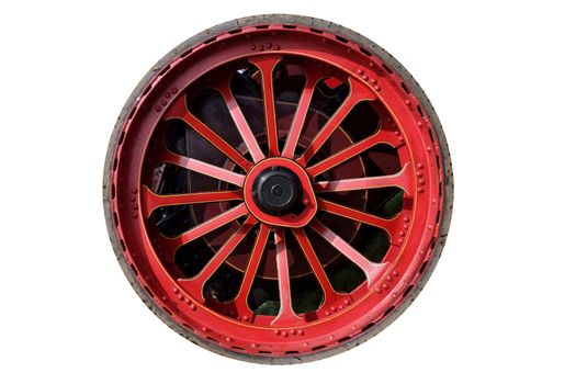 Isolated steam traction engine wheel, red with thin rubber tyre