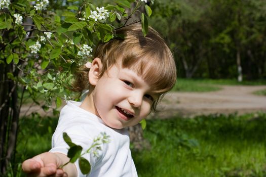 Girl demonstrating a white flower