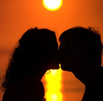 Young couple is kissing on the beach