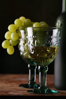goblet in medieval style with new wines, still-life with grape