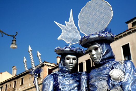 A  masked couple, dressed in blue, at the Venice Carnival