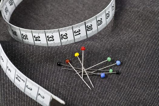Pins and measuring tape on fabric, ready for sewing.