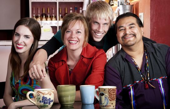 Four friends posing in a coffee house