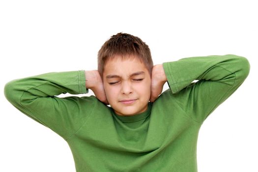 teenage boy with arms on ears and closed eyes isolated on white