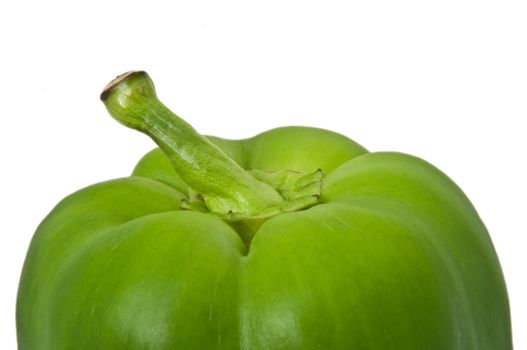 Close up capturing the top portion of a green bell pepper with white background.