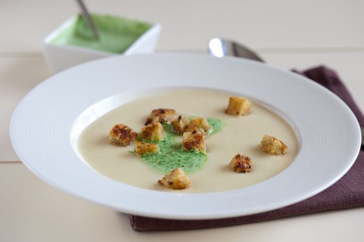 Freshly made parsnip soup with parsley cream
